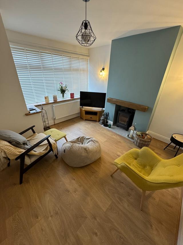 Living room floor and oak mantel
