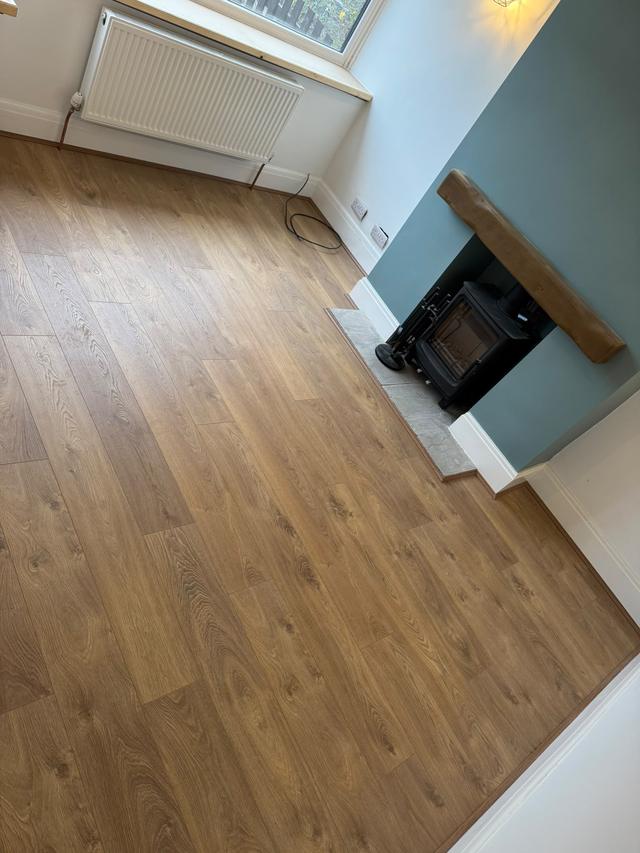 Laminate floor fitted around the hearth