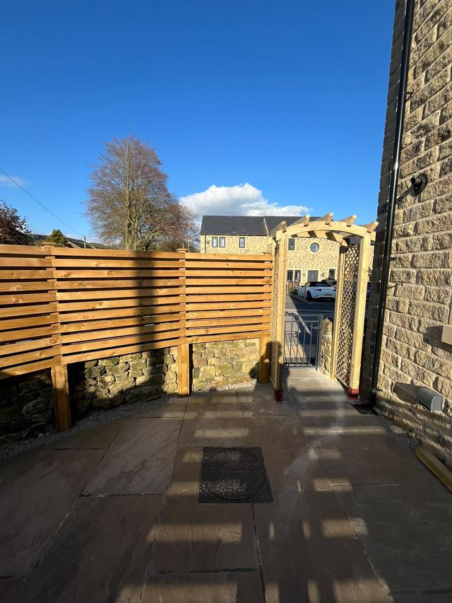 Slatted fence and pergola arch