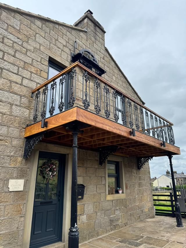 Hardwood balcony with cast-iron railings
