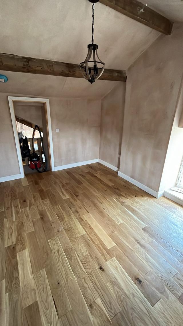 Solid oak floor under exposed beams